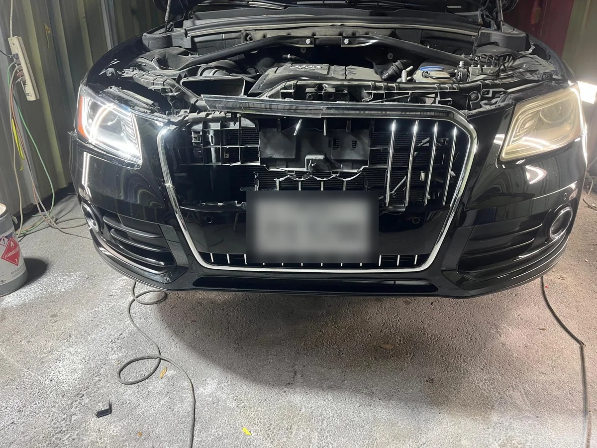 Audi Q5 with the front bumper cover removed for replacement