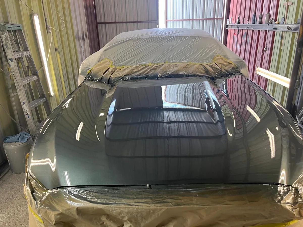 Car masked with paper and tape, hood painted