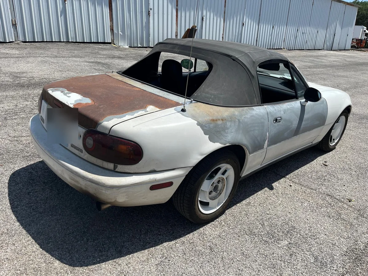 Rusted trunk and rear of the Miata before the work