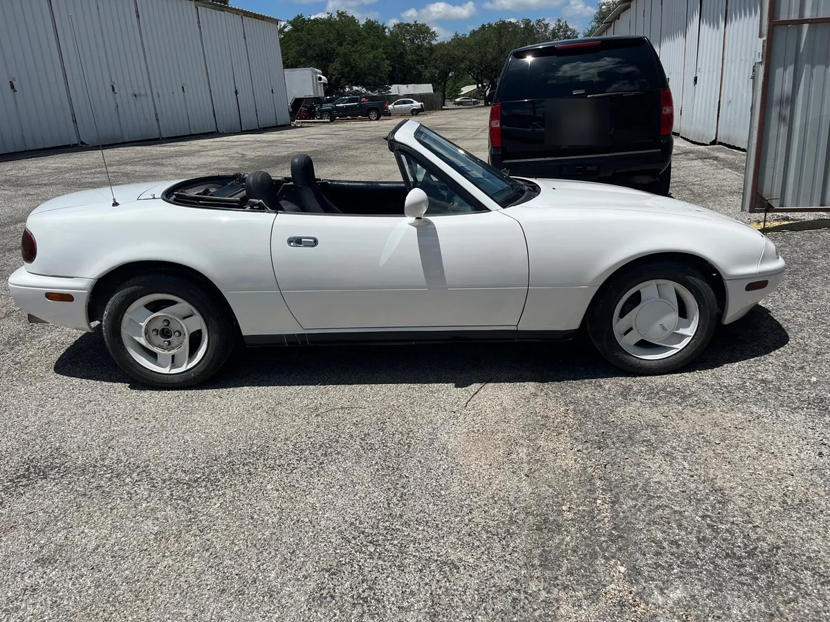 The same Miata restored in white, top down