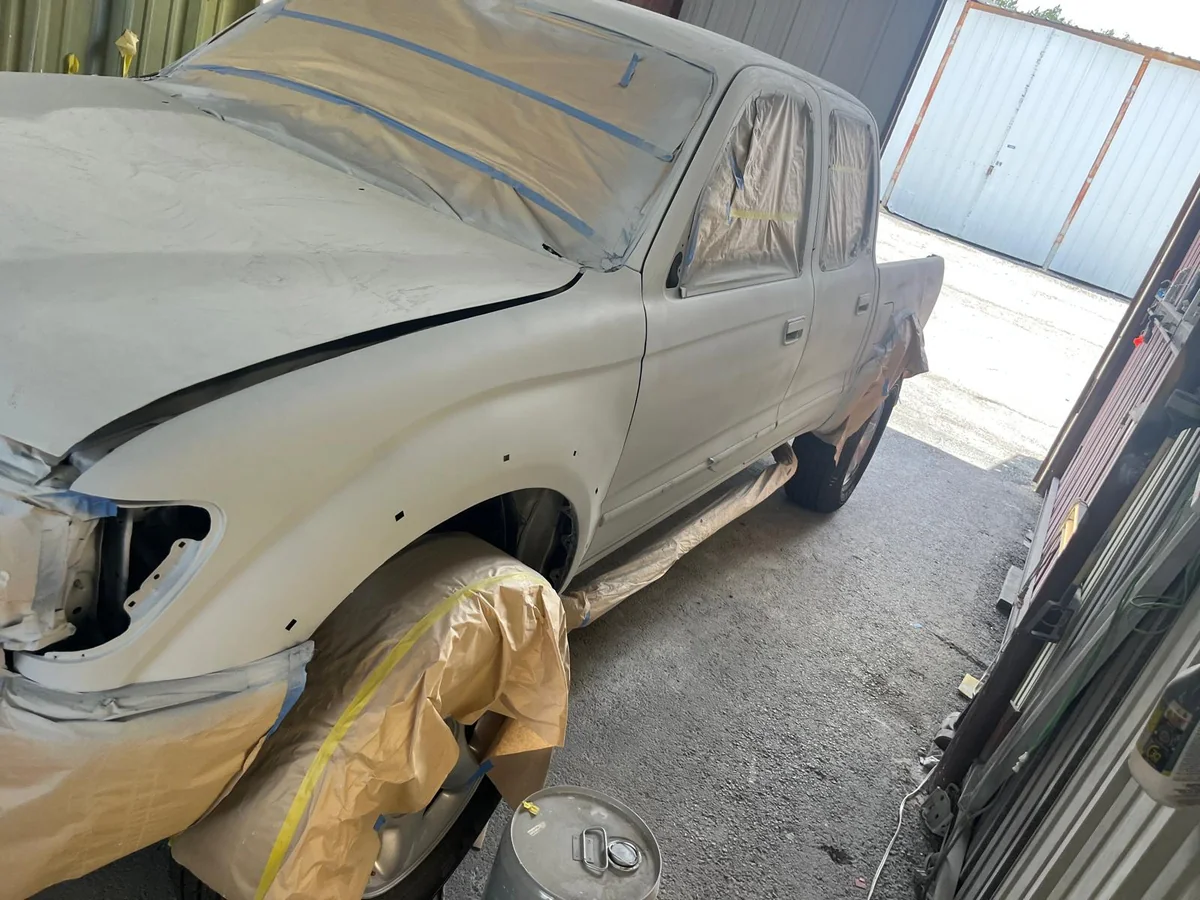 Toyota Tacoma front end repaired and in primer, masked for paint